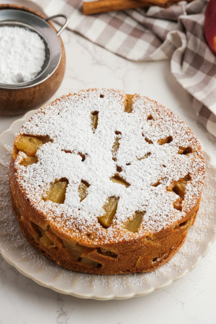 dusting of powdered sugar on apple cake