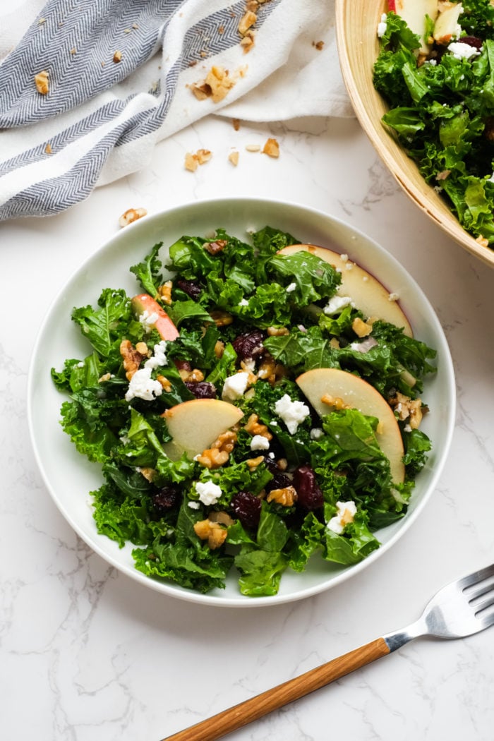 serving a Kale Salad with Apples and walnuts