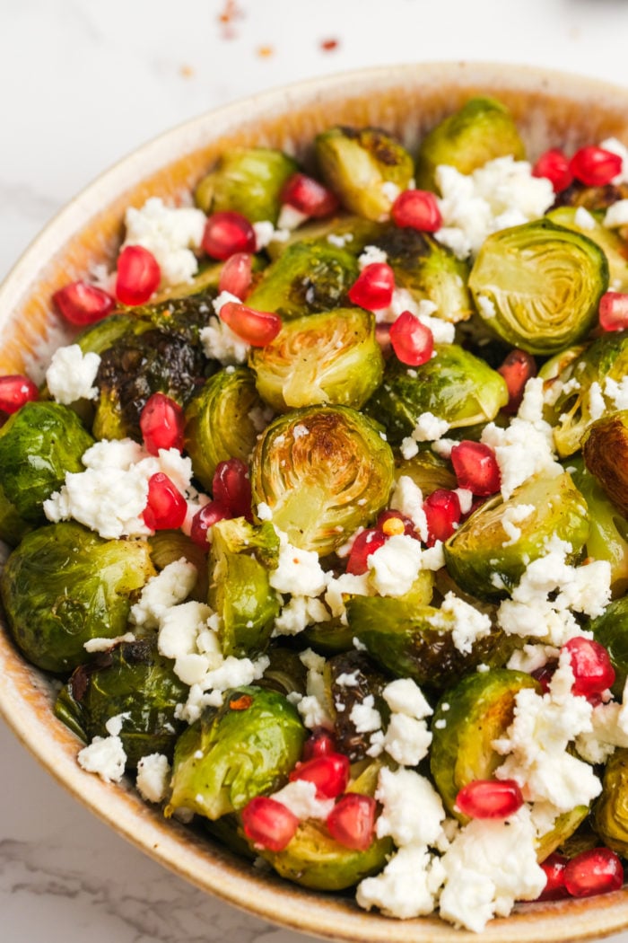 pomegranate seeds and feta cheese on brussels sprouts