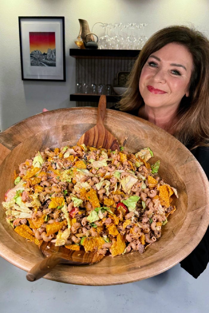 woman holding an epic bowl with taco pasta salad