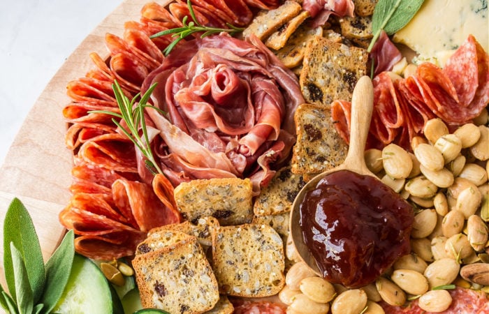 a salami rose flower on cheese board