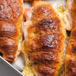 a cheesy croissant filled with ham and Swiss