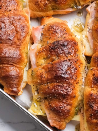 a cheesy croissant filled with ham and Swiss