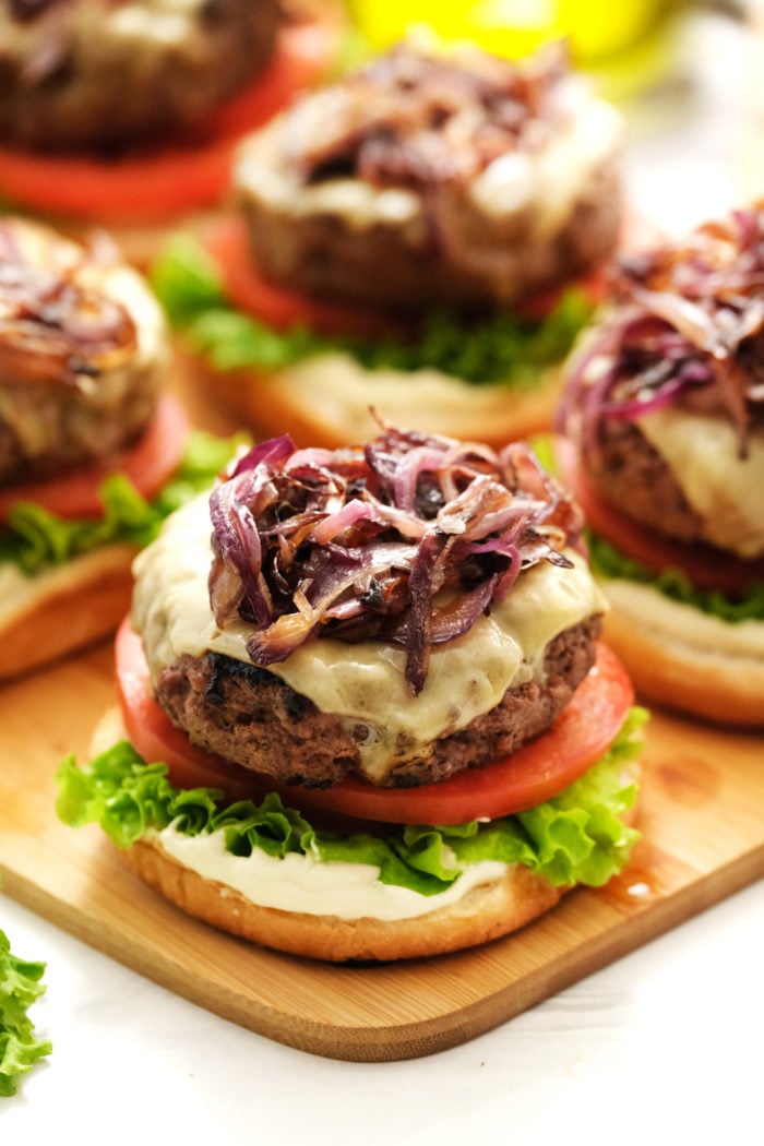 adding onions to a burger