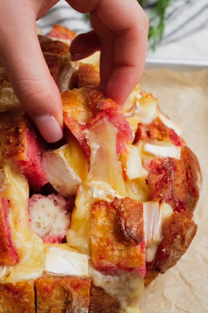 bite of cheesy Cranberry Brie Pull-Apart Bread