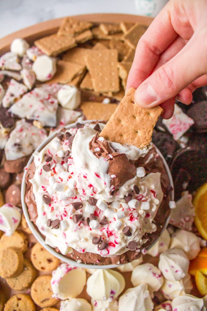 dipping a graham cracker into chocolate dip