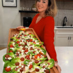 holding a big board with lettuce cups
