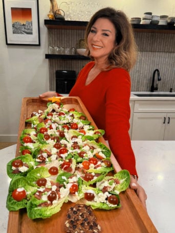 holding a big board with lettuce cups