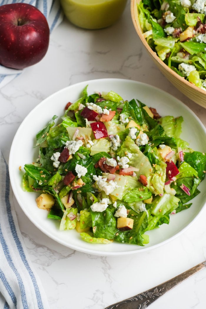 serving of salad with apples, nuts, cheese