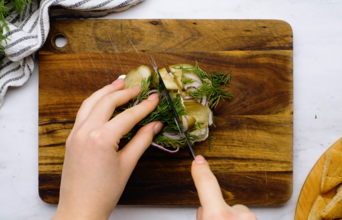 cutting and preparing the Dill Pickle Cream Cheese