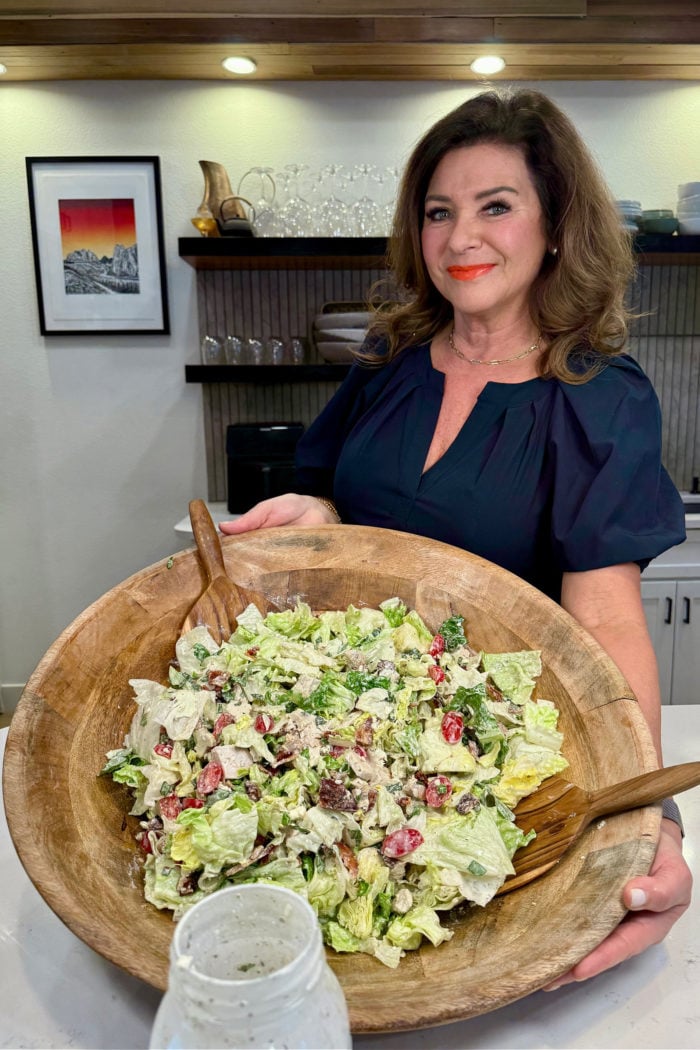 holding an epic salad bowl with Caesar wedge salad