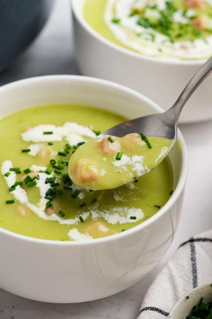 taking a bite of Leek and Potato Soup with Ham