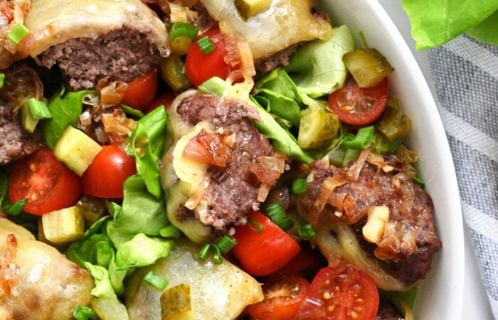 a cheesy bite of salad with hamburger