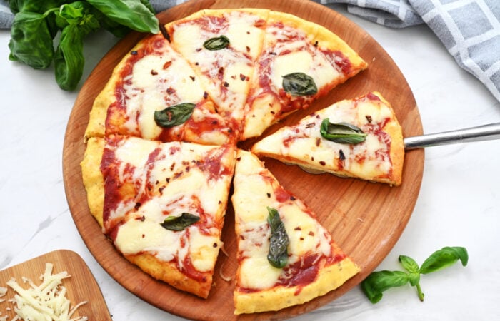cutting pieces of Cottage Cheese Pizza