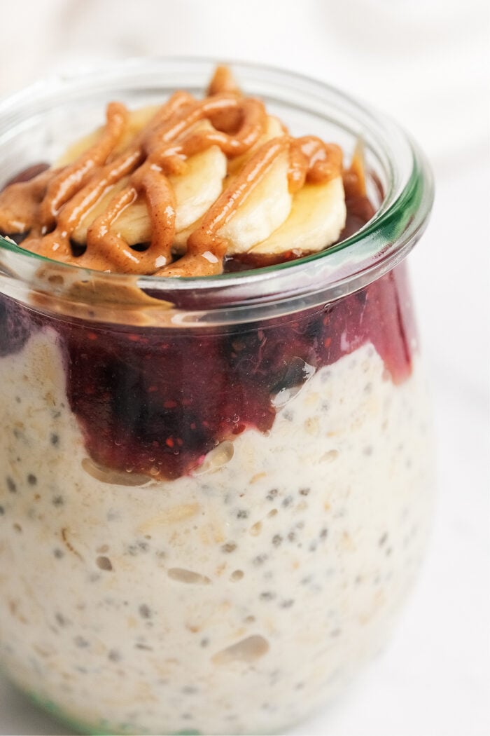 Berry Cheesecake Overnight Oats with drizzle peanut butter