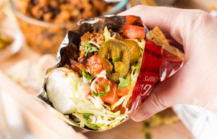 walking taco with fritos, sour cream, and jalapeno