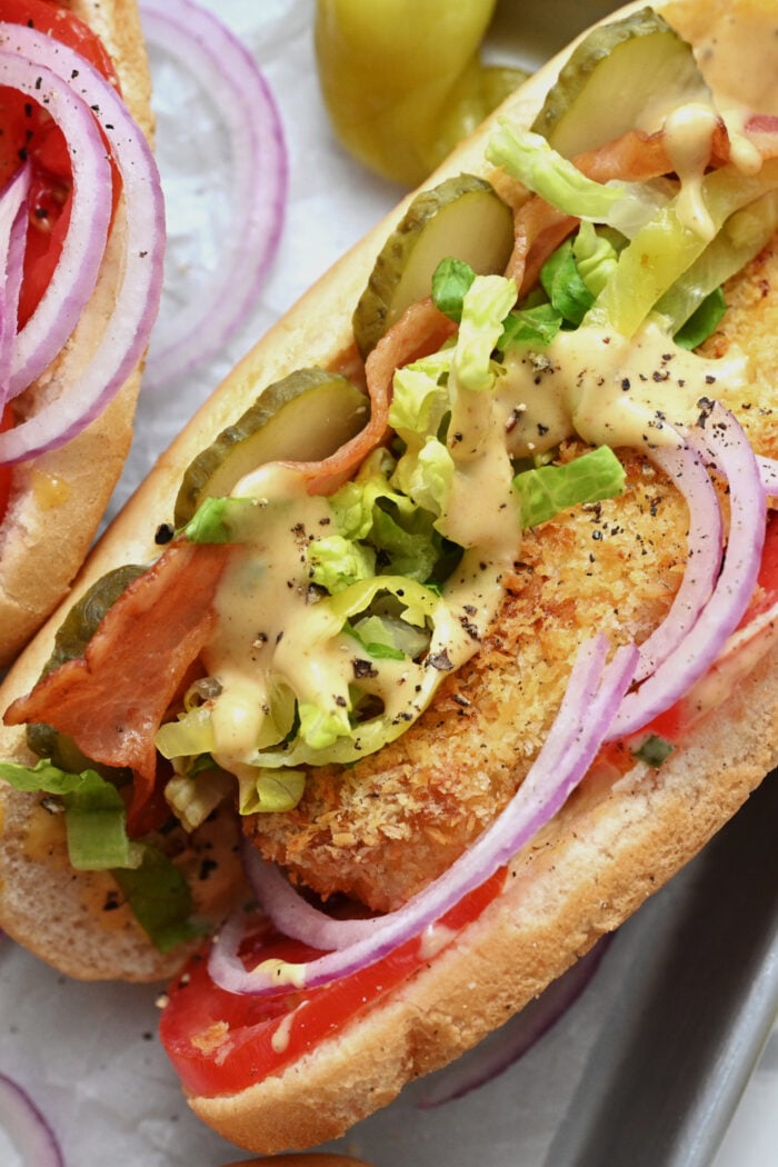 putting sauce on a chicken sandwich