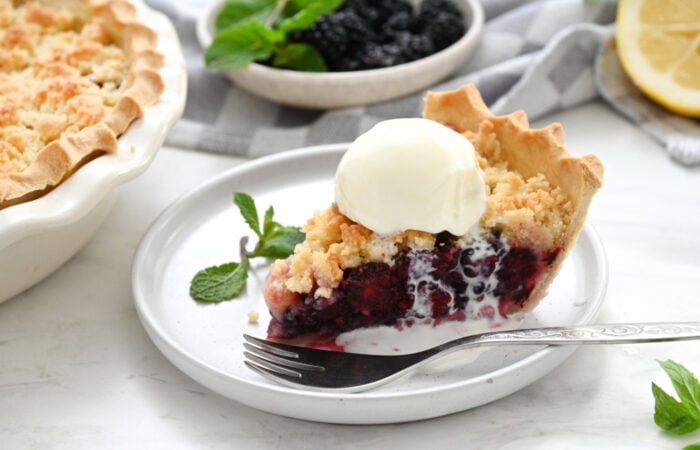a slice of Blackberry Crumble Pie with ice cream