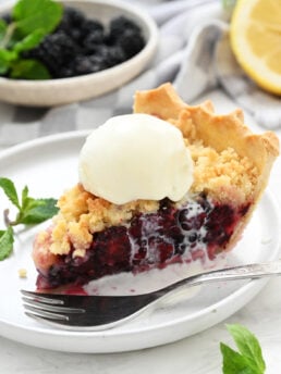 a piece of berry pie with melted ice cream