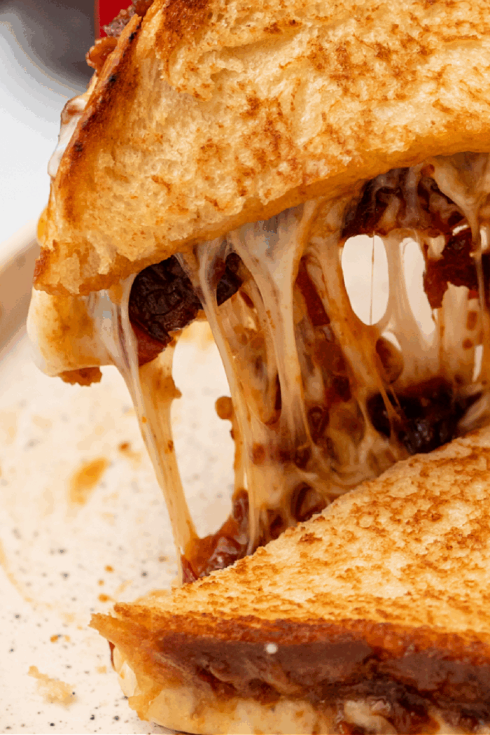 a cheesy grilled cheese sandwich with bacon