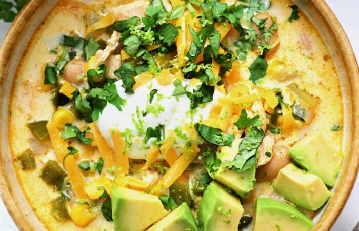white chicken chili with sour cream and avocado