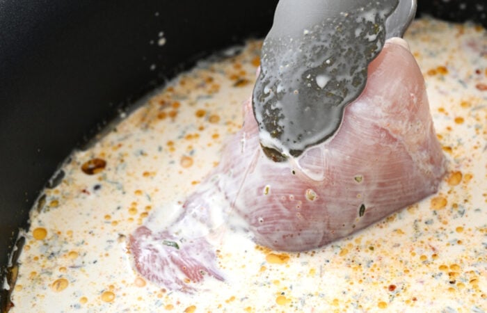 adding chicken to slow cooker