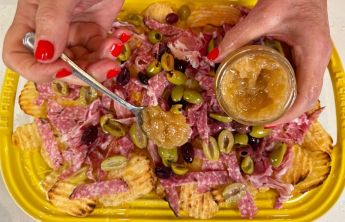 adding onion jam to charcuterie