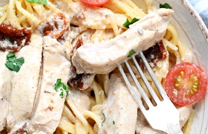 a bite of chicken with a fork
