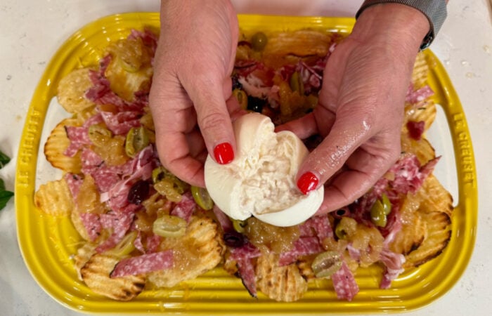 breaking apart a burrata cheese ball