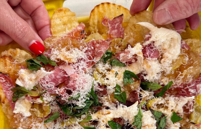 taking a bite of nachos