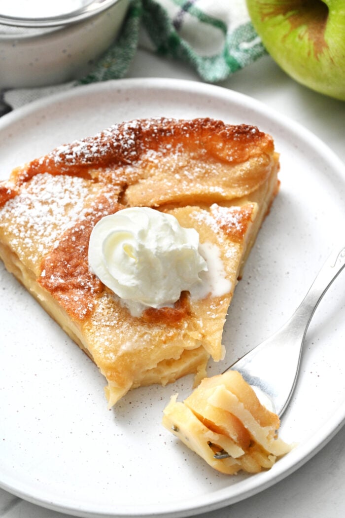 taking a bite of Clafoutis aux Pommes