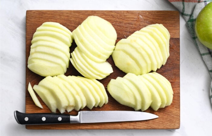 slicing green, peeled apples with a knife