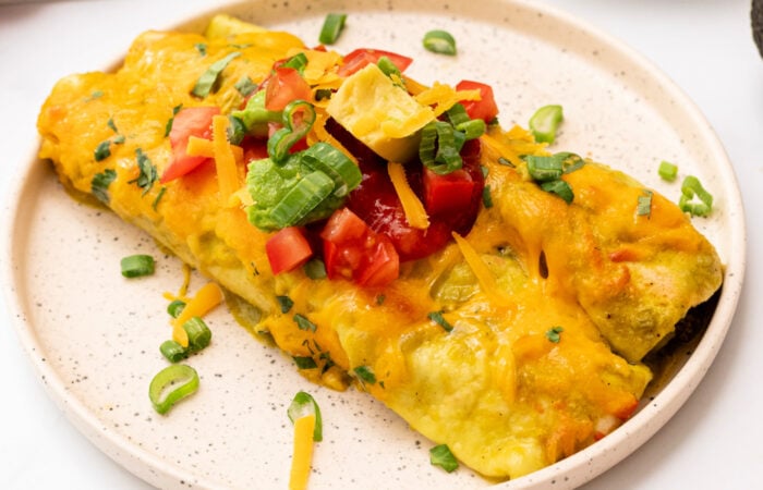 2 enchiladas on a serving plate