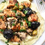 a serving of chicken on mashed potatoes