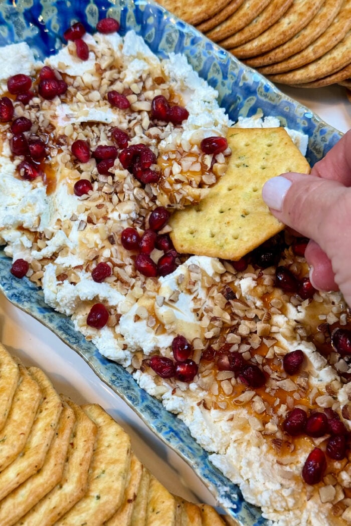 a butter cracker with cheese spread