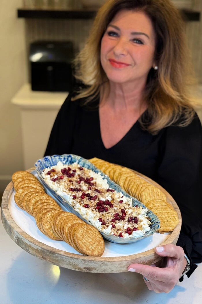 woman holding a Boursin Appetizer with crackers