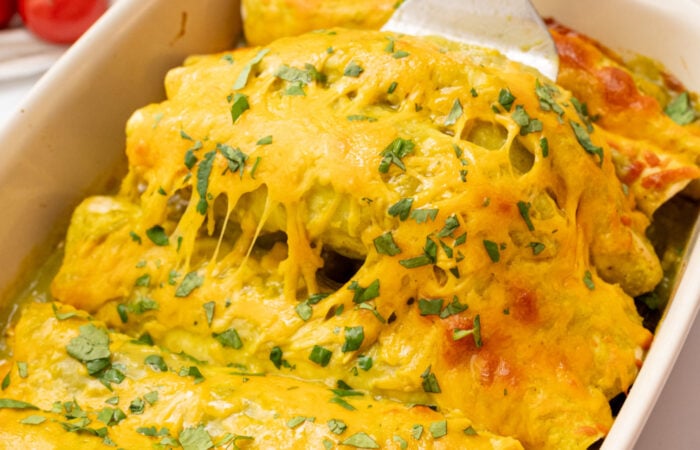 serving cheesy green enchiladas