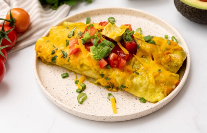 a plate of green enchiladas with beef
