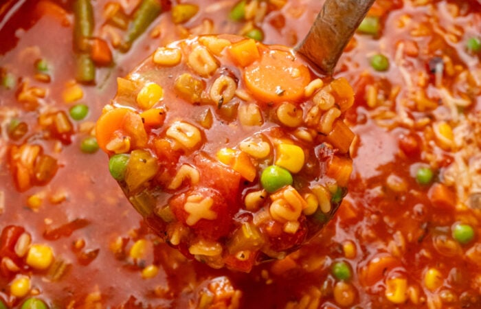 scooping out veggie soup