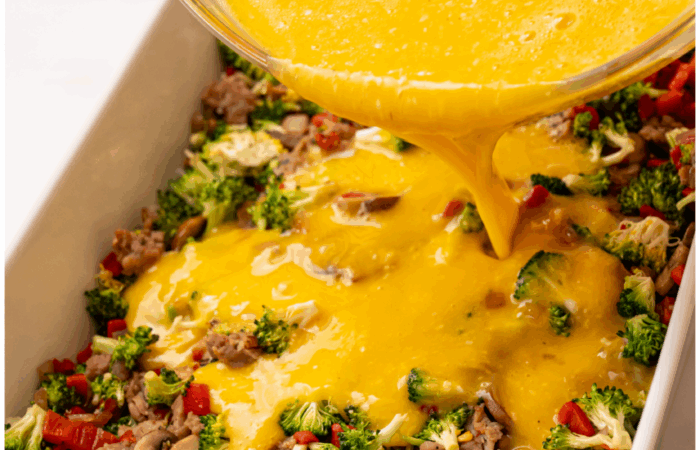 pouring egg mixture on veggies/meat