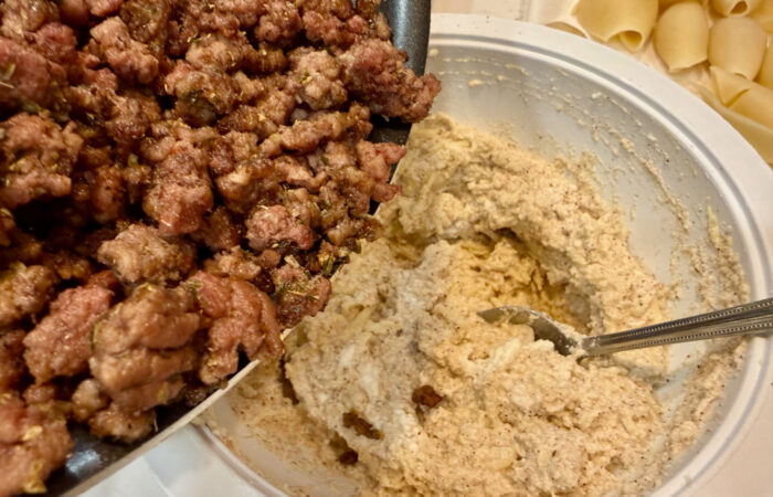 adding meat to ricotta cheese