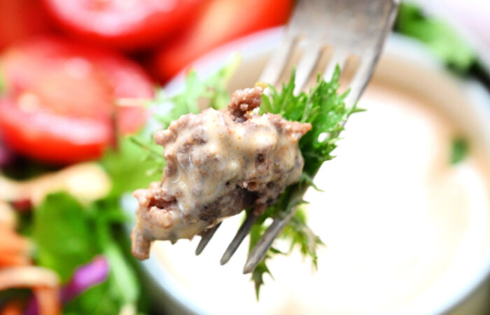 a bite of burger and sauce (bowl)