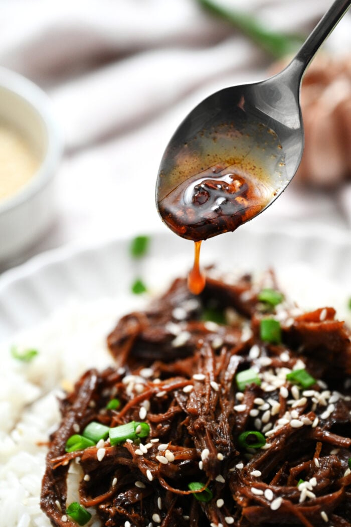 adding sauce to beef