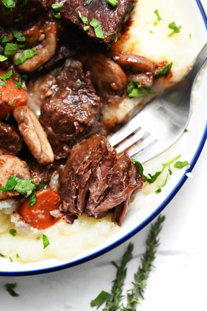 a bite of Beef Bourguignon (French Red-Wine Beef Stew)