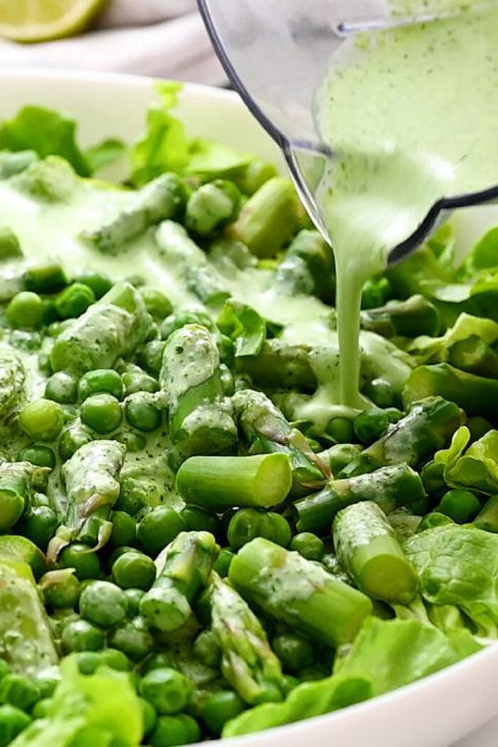 pouring dressing over salad