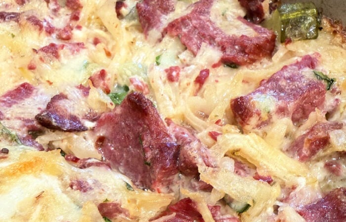 cheesy bite of Reuben Dip wit sauerkraut