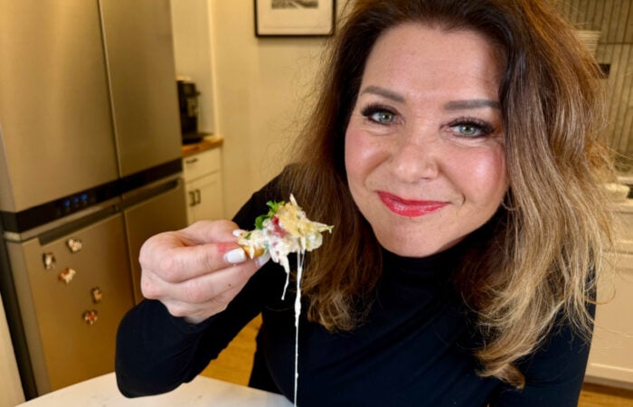 woman taking a bite of Reuben Dip