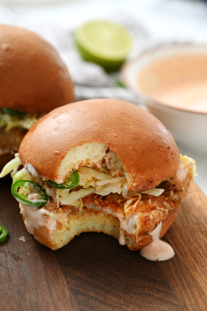a huge bite out of the fish sandwich
