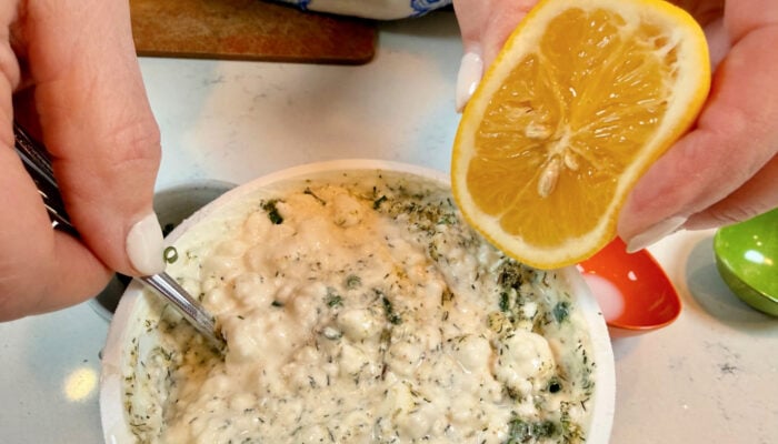 squeezing lemon on dip