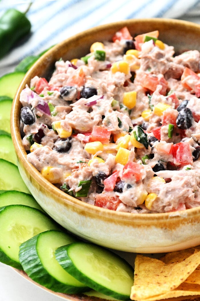 a bowl of tuna dip with cucumbers